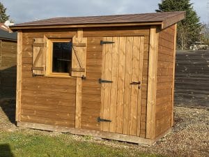 Abri de jardin en bois neuf avec fenêtre et porte.